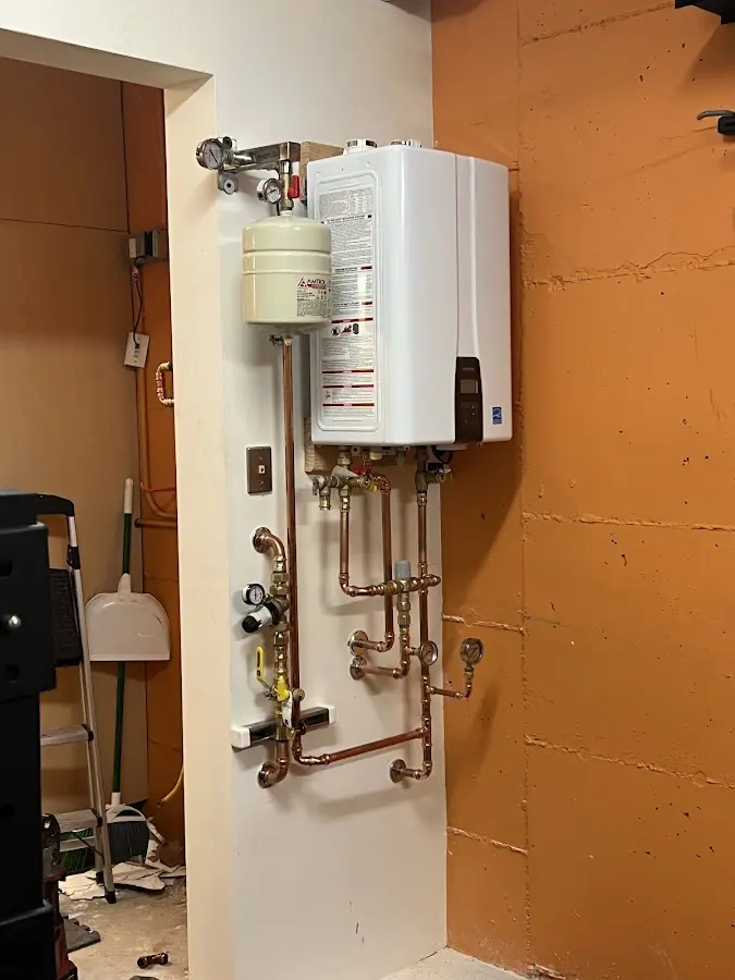 Plumbing technician inspecting water heater connections in Bear Valley Springs